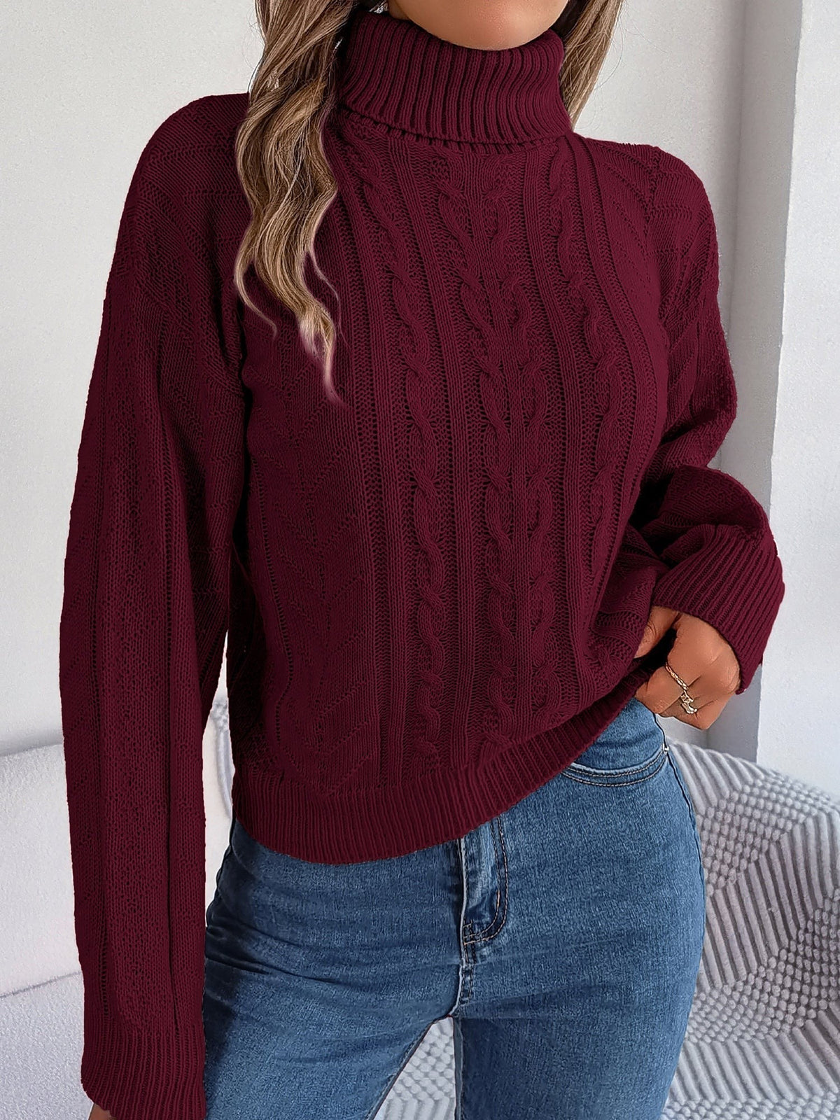 Cable-knit roll neck jumper