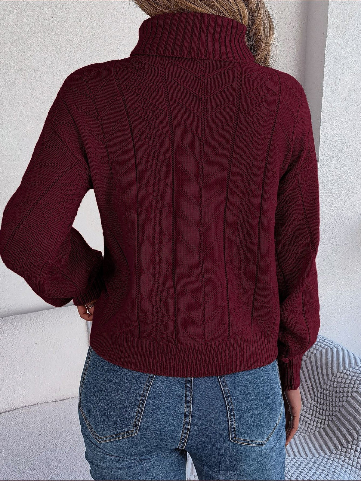 Cable-knit roll neck jumper