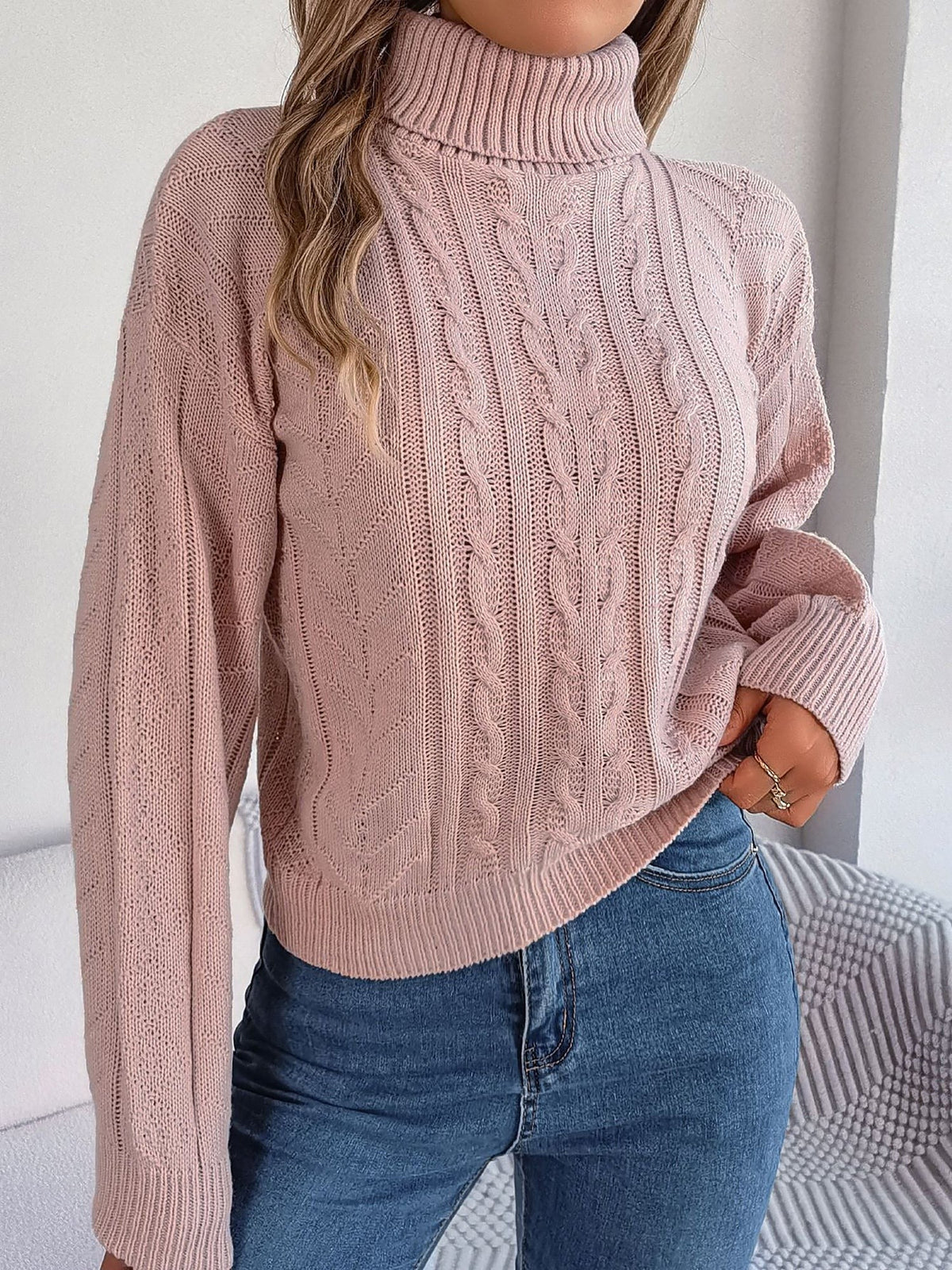 Pink cable-knit roll neck jumper